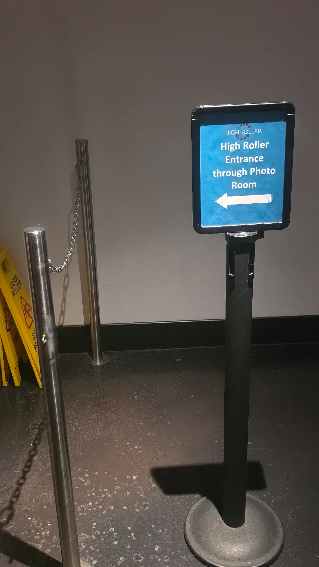 High Roller entrance sign pointing left through the Photo Room